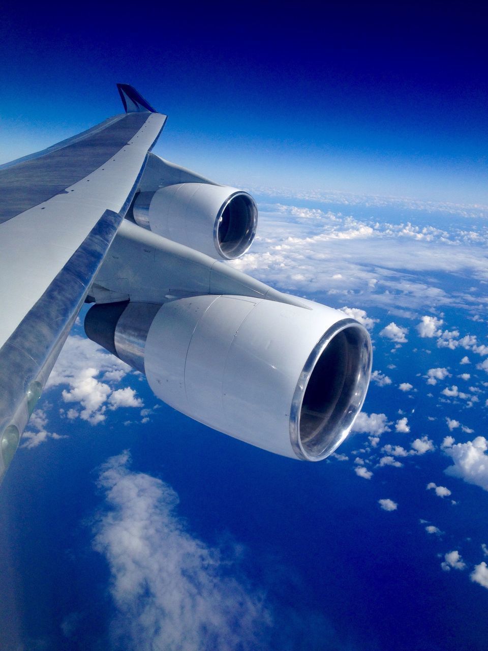 LOW ANGLE VIEW OF AIRPLANE AGAINST BLUE SKY