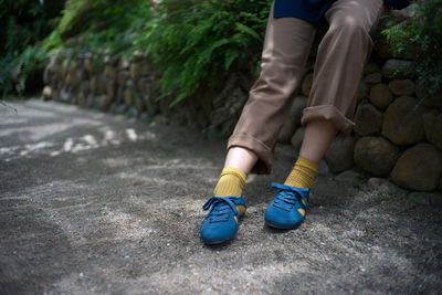 Low section of person standing on footpath