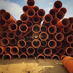 Stack of water pipes on field