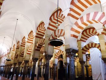 Low angle view of lights hanging on ceiling of building