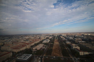 High angle view of cityscape against cloudy sky