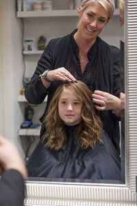 Girl having her hair cut