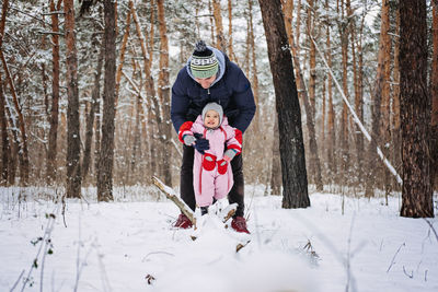 Outdoor family activities for happy winter holidays. happy father playing with little baby toddler