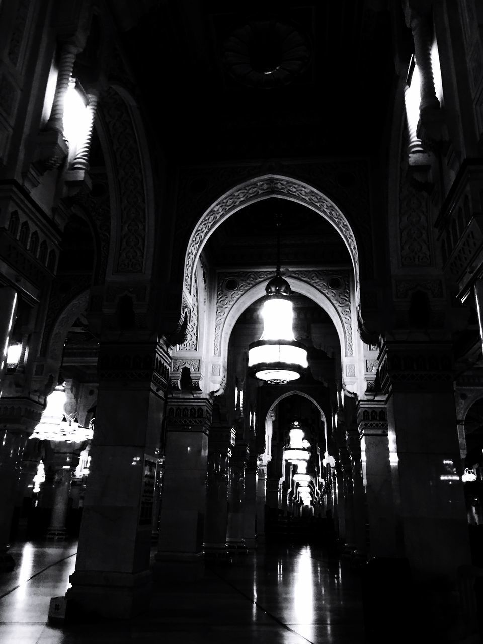 LOW ANGLE VIEW OF ILLUMINATED CORRIDOR OF CATHEDRAL