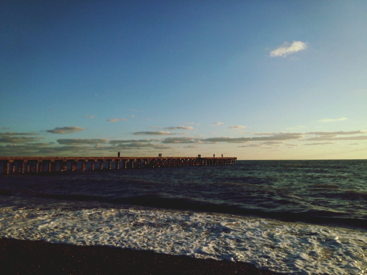 sea, water, horizon over water, sky, tranquil scene, tranquility, scenics, beach, beauty in nature, shore, nature, sunset, pier, idyllic, cloud - sky, outdoors, calm, remote, blue, no people