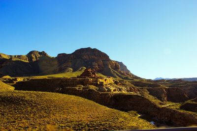 Scenic view of mountain against blue sky