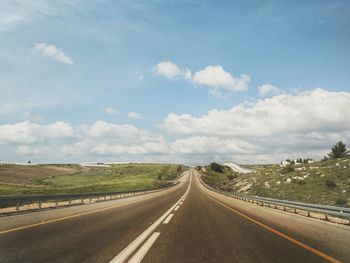 Empty road along countryside landscape