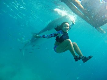 Young woman jumping in swimming pool