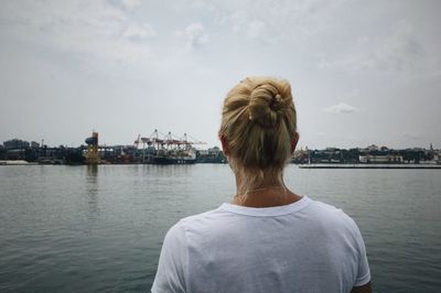 Woman looks at the odessa port. photo from the back