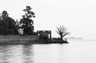 Scenic view of lake by building against clear sky