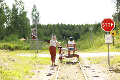 Mother with daughter riding handcar