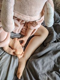 High angle view of girl sitting on bed at home