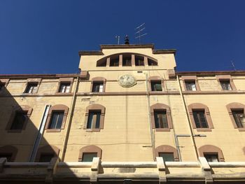 Low angle view of building against clear blue sky