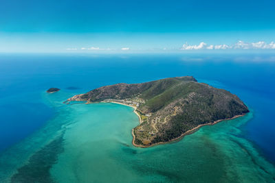 Aerial view of sea against blue sky