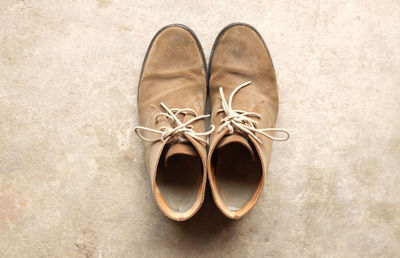 High angle view of shoes on concrete floor