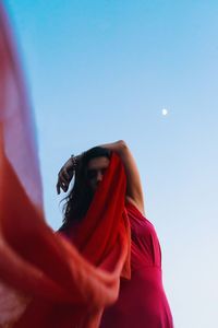 Low angle view of woman against sky