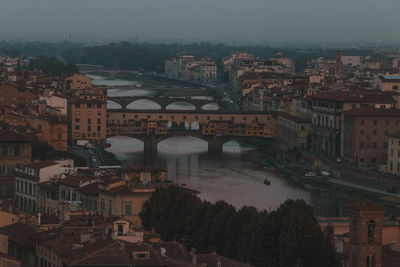 High angle view of bridge over river amidst buildings in city