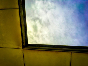 Low angle view of yellow window against sky