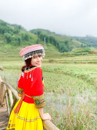 Portrait of woman standing on field