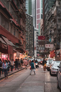 Group of people on city street amidst buildings