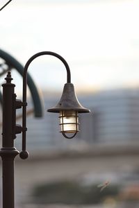 Close-up of metal hanging against sky