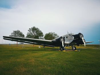 View of airplane on airport runway against sky