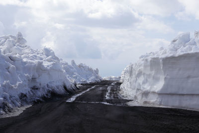 Scenic view of waterfall against sky