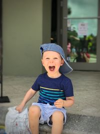 Cute boy sitting outdoors