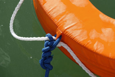 High angle view of rope tied up to life belt