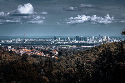 Aerial view of buildings in city against sky