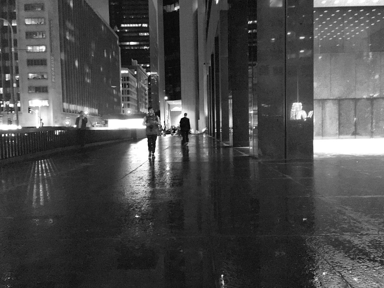 building exterior, architecture, city, built structure, street, walking, city life, rain, wet, men, full length, reflection, building, lifestyles, rear view, water, season, road