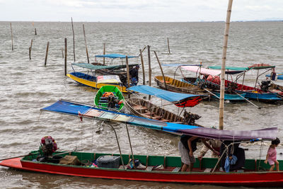 High angle view of boats moored at sea shore against sky