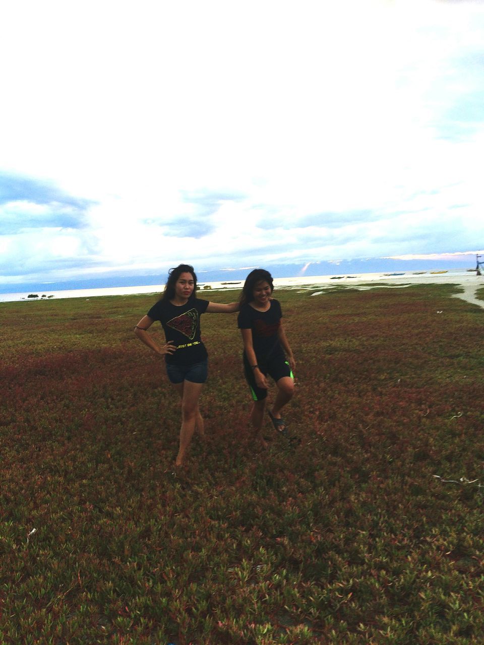 sky, full length, leisure activity, two people, real people, land, lifestyles, women, field, cloud - sky, people, nature, standing, casual clothing, plant, togetherness, day, grass, front view, running, outdoors, teenager