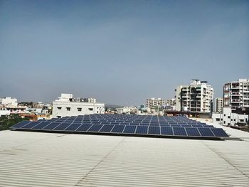 Scenic view of solar panels on residential buildings against clear sky