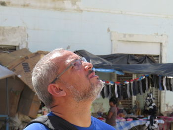 Mature man looking up at market