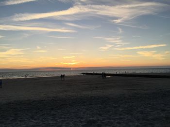 Scenic view of beach against sky during sunset