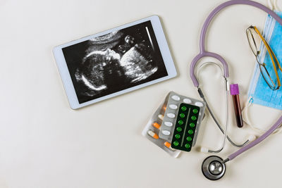 High angle view of stethoscope on white background