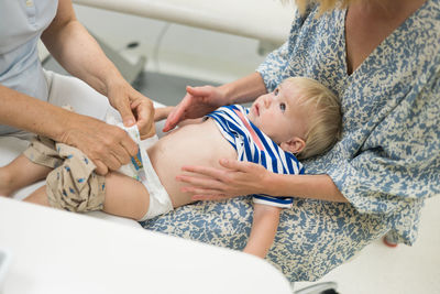 Midsection of doctor examining patient at spa