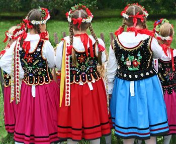 Women in traditional clothing on field
