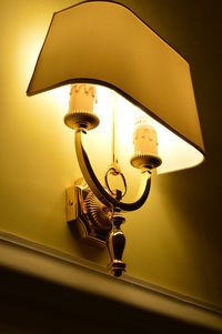 Low angle view of illuminated lamp at home