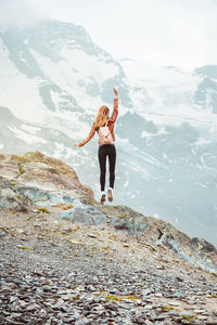 Rear view of woman standing on mountain