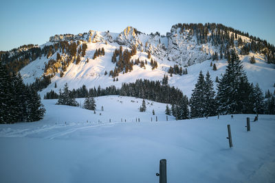 Snow covered landscape against sky