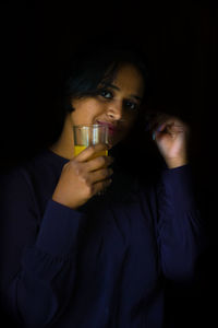 Young woman drinking glass