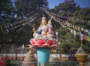Buddha statue against trees