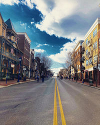 Surface level of road by buildings against sky