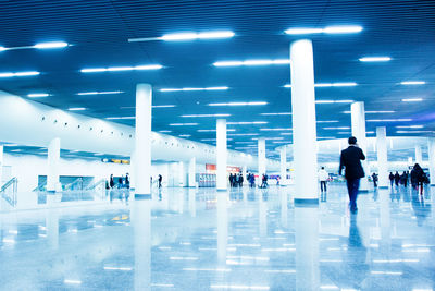 People walking in illuminated airport