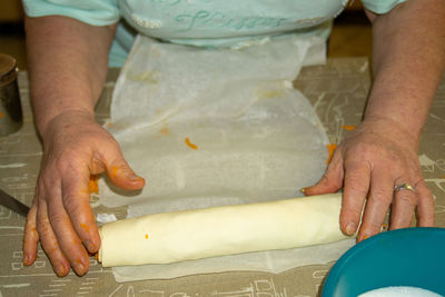 Midsection of woman preparing food on table