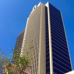 Low angle view of modern building against clear blue sky