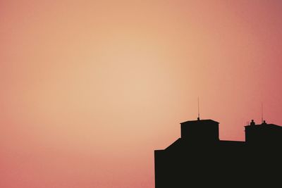 Low angle view of built structure at sunset