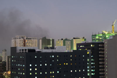 Buildings in city against sky at night